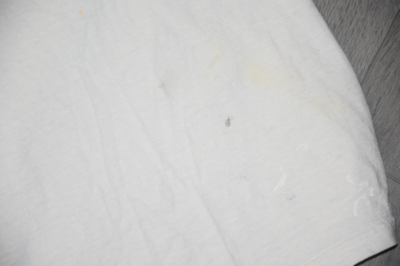 May include: White cotton fabric with several small stains.