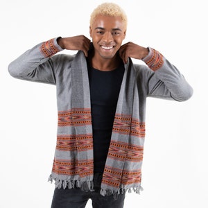 Male model with a gray cardigan with fringes on the ends. Accented with red diamonds.