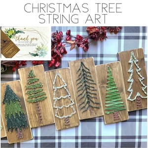 May include: Six rectangular wooden boards featuring Christmas tree string art designs. Each board displays a unique tree pattern created with colored thread wrapped around small metal nails, set against a dark stained wood background.