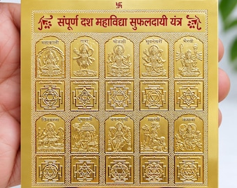 May include: A square gold-plated metal plate featuring the Sampurna Dash Mahavidya Sufaldayi Yantra. The surface displays ten embossed deity figures and corresponding geometric yantra patterns with Hindi text. The bottom edge reads 24 C. GOLD PLATED.