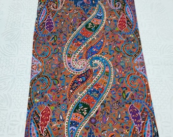 May include: A brown paisley patterned shawl with a colorful border. The shawl is made of soft fabric and has a luxurious feel.