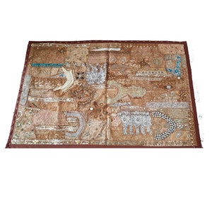 May include: A brown patchwork wall tapestry with intricate embroidery and embellishments. The tapestry features a variety of textures and patterns, including sequins, beads, and thread.