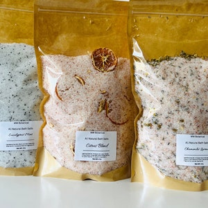 May include: Three clear plastic bags filled with bath salts. The bags are labeled with the text "MW Botanical" and the scent of each bath salt: "Eucalyptus/Mint", "Citrus Blend", and "Chamomile Lavender".