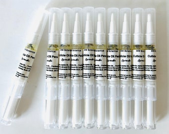May include: A collection of cuticle oil pens with clear plastic tubes and white caps. The pens are filled with a light yellow liquid and small plant particles. The label reads "MW Botanical Cuticle Oil Pen" with "Lavender" below.