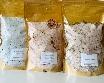 May include: Three clear plastic bags filled with bath salts. The bags are labeled with the text "MW Botanical" and the scent of each bath salt: "Eucalyptus/Mint", "Citrus Blend", and "Chamomile Lavender".