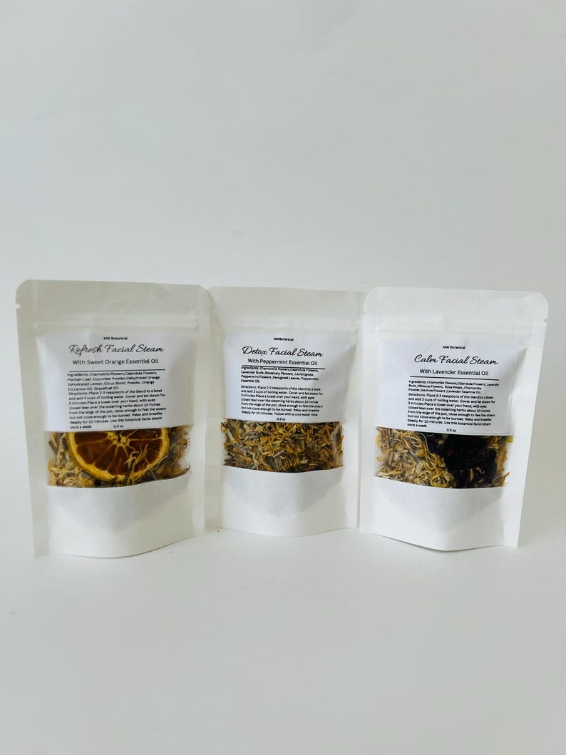 May include: Three white pouches with labels for facial steam. The pouches contain dried herbs and flowers. The labels read "Refresh Facial Steam with Sweet Orange Essential Oil", "Detox Facial Steam with Peppermint Essential Oil", and "Calm Facial Steam with Lavender Essential Oil".