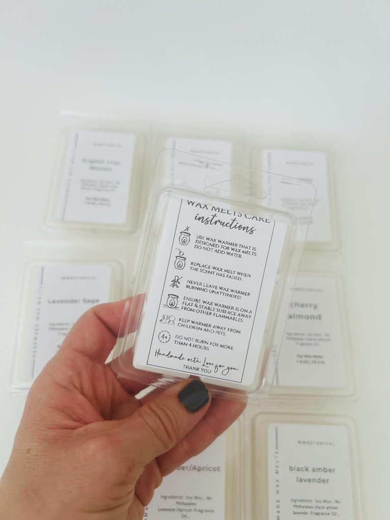May include: A clear plastic clamshell package containing wax melts with a white instructional label. The label features text titled WAX MELTS CARE INSTRUCTIONS, including safety icons and warnings about wax warmer use, plus a thank you note.