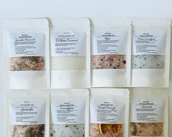 May include: Eight white pouches of bath salts with different scents. The scents are Lavender Chamomile, White Coconut, Rose, Mint Eucalyptus, Lavender, Eucalyptus, Sweet Orange, and Chamomile.