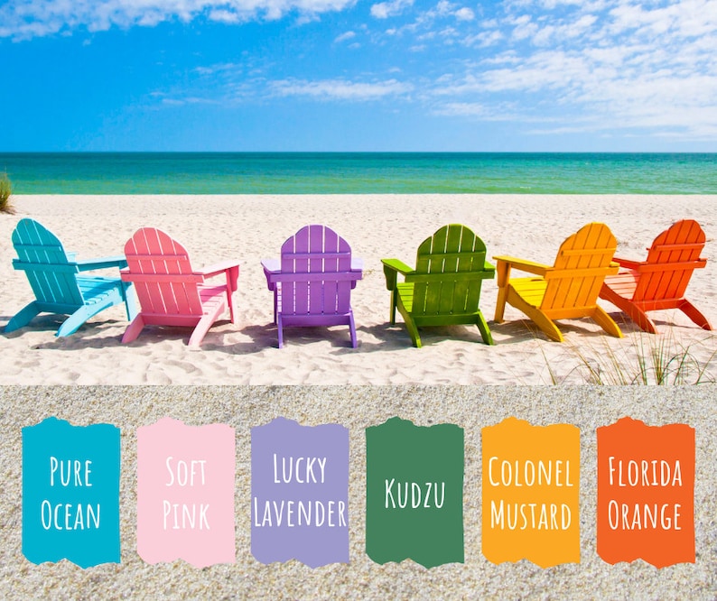 May include: Six colorful Adirondack chairs on a sandy beach with a blue ocean in the background. The chairs are painted in shades of blue, pink, purple, green, yellow, and orange. The colors are labeled with names like "Pure Ocean", "Soft Pink", "Lucky Lavender", "Kudzu", "Colonel Mustard", and "Florida Orange".