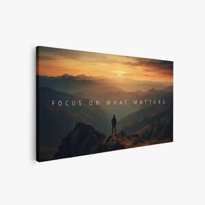 May include: A silhouette of a person standing on a mountaintop overlooking a vast landscape of rolling hills at sunset. The sky is a vibrant orange and yellow, and the mountains are a deep blue. The text "FOCUS ON WHAT MATTERS" is superimposed on the image.