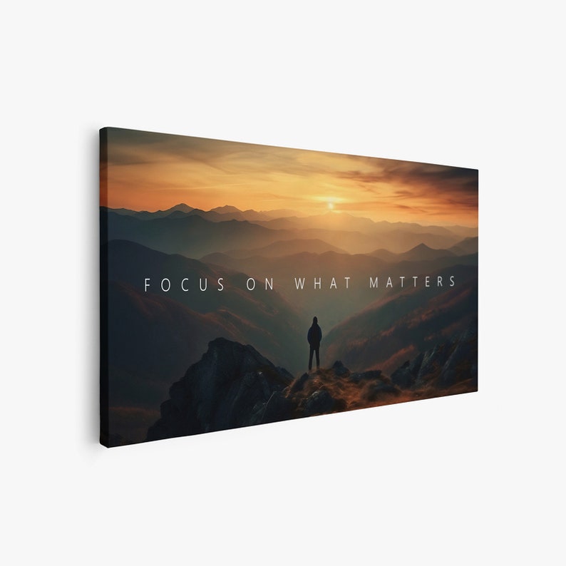 May include: A silhouette of a person standing on a mountaintop overlooking a vast landscape of rolling hills at sunset. The sky is a vibrant orange and yellow, and the mountains are a deep blue. The text "FOCUS ON WHAT MATTERS" is superimposed on the image.