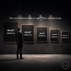 May include: A man stands before a display of framed art prints in various sizes. The prints are black with gold frames, and the sizes are labeled in inches and centimeters: 48x36" (120x90 cm), 40x30" (100x75 cm), 36x24" (90x60 cm), 24x18" (60x45 cm), and 18x12" (45x30 cm). The text above reads, "Not sure which size to get? This should help."