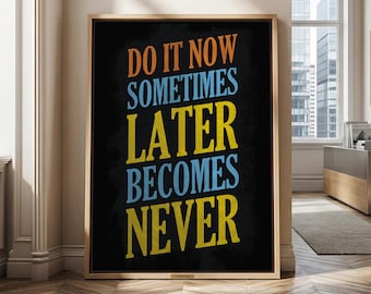 May include: A rectangular wall art piece in a light wood frame featuring a black background with the text DO IT NOW SOMETIMES LATER BECOMES NEVER in orange, light blue, and yellow block lettering, displayed in a vertical orientation.