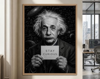 May include: A framed black and white wall art print featuring a portrait of Albert Einstein with messy hair, wearing a dark jacket. He holds a small white sign with the text STAY CURIOUS. The background displays space, planets, and mathematical formulas.