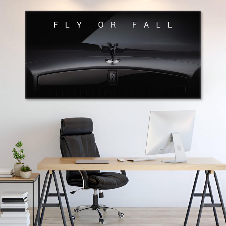 Puede incluir: Impresi&oacute;n en blanco y negro que muestra un adorno de cap&oacute; de Rolls-Royce y el texto "FLY OR FALL". La imagen est&aacute; encima de un escritorio con una computadora y una silla de oficina negra.