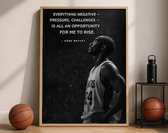 May include: A framed black and white wall art print featuring a side profile of Kobe Bryant in a basketball jersey. The text reads: EVERYTHING NEGATIVE — PRESSURE, CHALLENGES — IS ALL AN OPPORTUNITY FOR ME TO RISE. — KOBE BRYANT. The print is in a light wood frame.