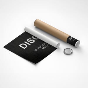 May include: A black and white poster with the text "DISCO IS THE BRIGHTEST AND A" printed on it. The poster is rolled up and partially unrolled, revealing the text. The poster is sitting on a white surface.