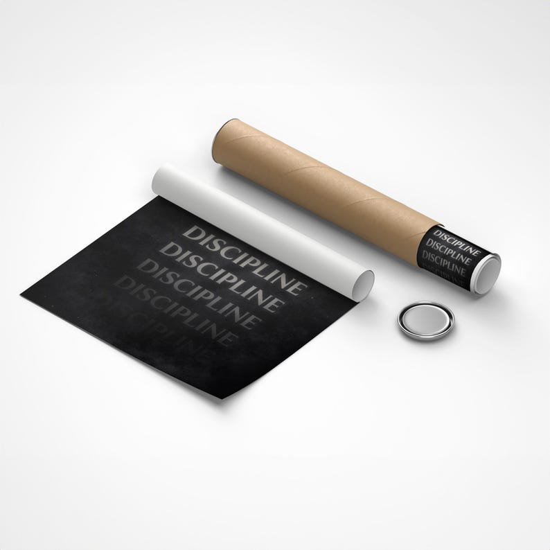 May include: A rolled poster with the word "DISCIPLINE" repeated in a gray font on a black background. The poster is next to a white rolled paper, a brown cardboard tube, and a small silver button.