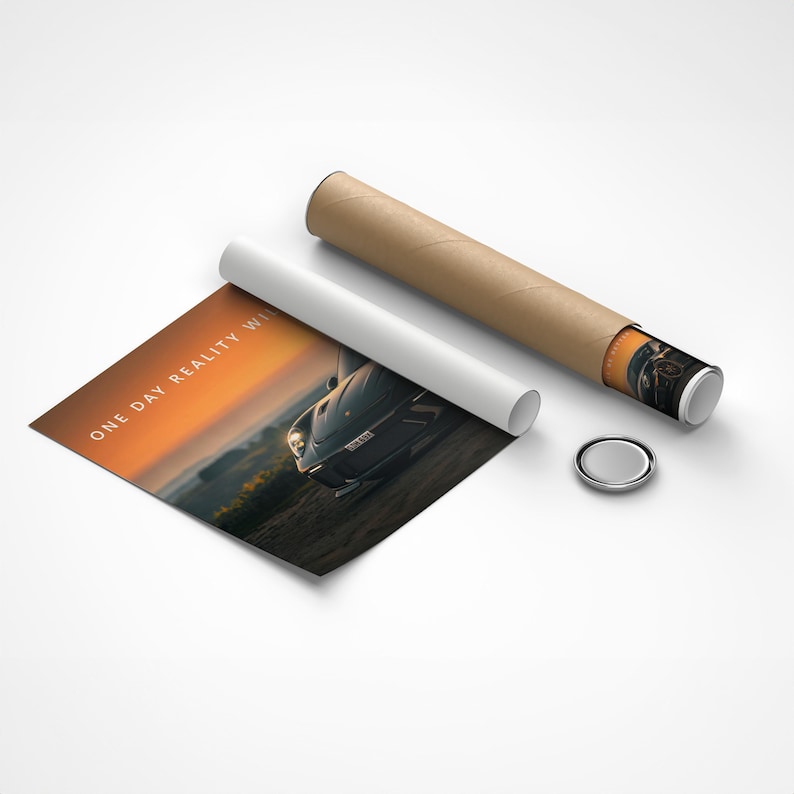May include: A poster print featuring a car on a road with the text "ONE DAY REALITY WINS" in white. The print is partially rolled up with a white paper and a brown cardboard tube. A small, silver, round object is also present.