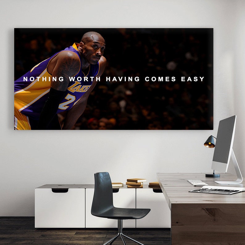 May include: A black and white photo of basketball player Kobe Bryant wearing a purple and gold Los Angeles Lakers jersey. The quote "NOTHING WORTH HAVING COMES EASY" is printed in white text on a black background.