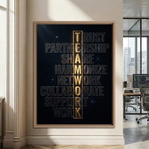 May include: A rectangular wall art piece in a light wood frame featuring a dark space-themed background. The word TEAMWORK is written vertically in gold letters, intersecting horizontal words: TRUST, PARTNERSHIP, SHARE, HARMONIZE, NETWORK, COLLABORATE, SUPPORT, WORK.