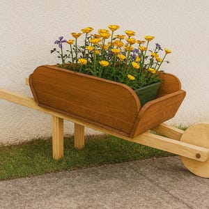 May include: A wooden wheelbarrow planter with a dark brown wooden bed and a light brown handle and wheel. The planter is filled with yellow and purple flowers, and sits on a concrete surface.