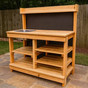 May include: A wooden outdoor play kitchen with a stainless steel sink and multiple shelves. The natural wood-toned structure has a dark pegboard backing and is designed for children's play. It is set on a stone patio.