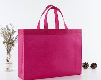 May include: A bright pink reusable shopping bag with two handles. The bag is made of non-woven fabric and has a flat bottom.