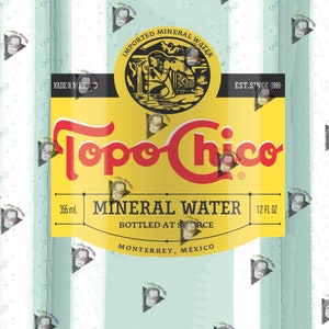May include: A yellow and red label with the text "Topo Chico Mineral Water" on a clear glass bottle. The label also includes the text "Imported Mineral Water", "Est. Since 1895", "355 mL", "12 FL OZ", "Bottled at Source", and "Monterrey, México".