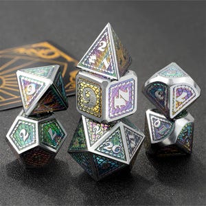 May include: A set of seven iridescent dice with a variety of numbers and symbols. The dice are made of metal and have a unique, textured finish.