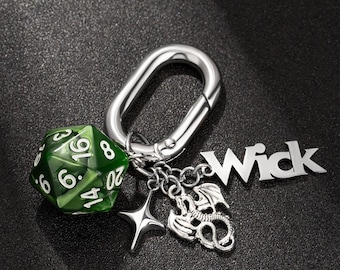 May include: A silver keychain with a green 20-sided die, a dragon charm, a star charm, and a silver charm with the word "Wick" on it.