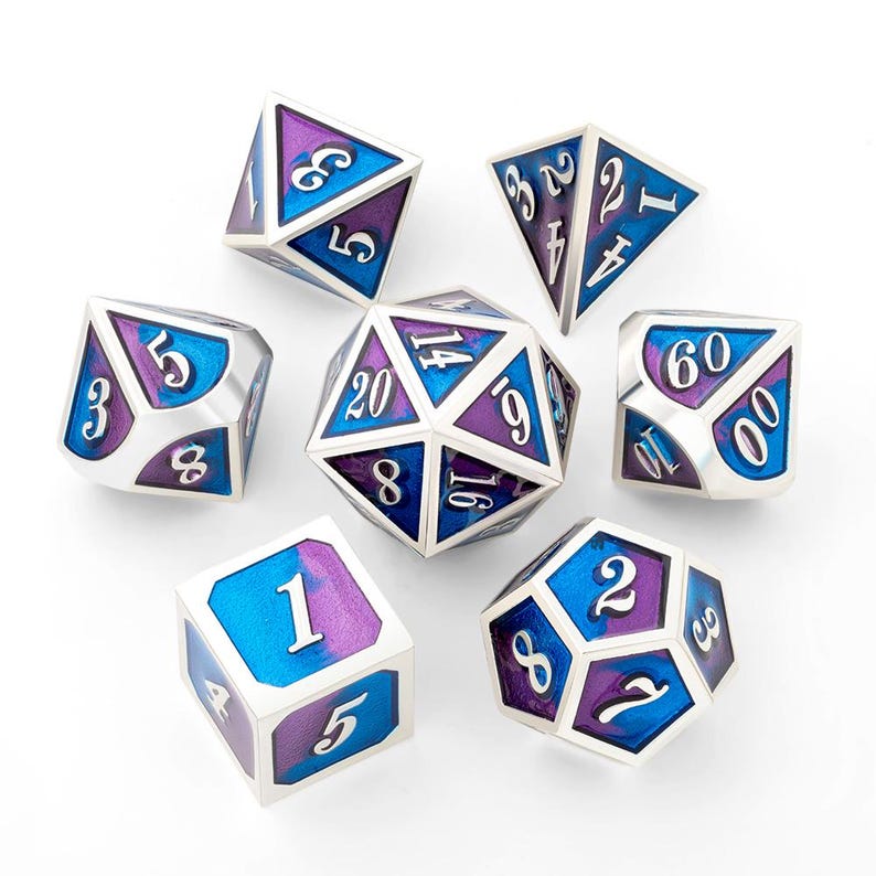May include: A set of seven polyhedral dice with a silver finish, featuring blue and purple color accents. Each die has white numbers. The dice are designed for tabletop role-playing games.