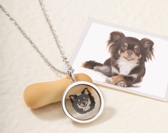May include: A silver necklace with a round pendant featuring a black and white image of a chihuahua. The pendant is clear and the image is visible through the glass.
