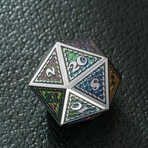 May include: A multi-sided iridescent die with a scale pattern and white numbers. The die is a 20-sided die with the numbers 2, 20, 15, and 8 visible.