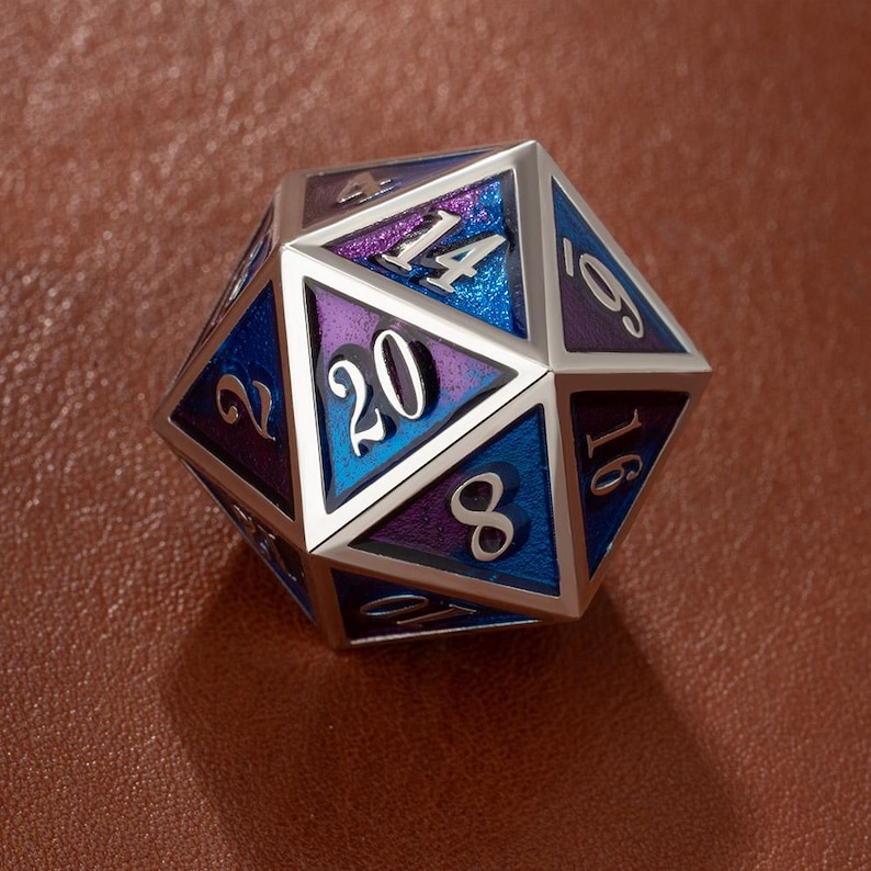 May include: A metallic D20 die with a silver frame and colorful triangular faces. The faces are painted with shades of blue and purple, with white numbers. This polyhedral die is used for tabletop role-playing games.