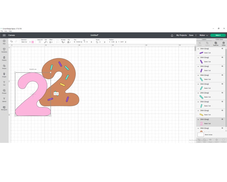 May include: Two pink and brown numbers, 22, shaped like donuts with sprinkles. The number 2 on the left is pink and the number 2 on the right is brown with purple, yellow, and teal sprinkles.