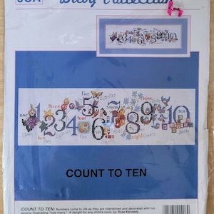 May include: A counted cross stitch pattern for a baby nursery. The pattern features numbers 1 through 10 with illustrations of objects representing each number. The pattern is titled "Count to Ten" and is part of the JCA Baby Collection.