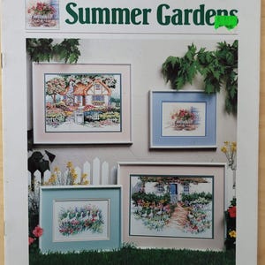 May include: A craft book titled "Summer Gardens" by Dawna Barton, featuring framed cross-stitch designs. The designs depict cottage scenes with flowers and gardens. The Dimensions logo is visible at the bottom.