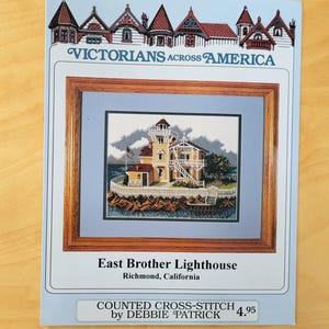 May include: A white ceramic mug with a black handle and the text "But First, Coffee" in a black, handwritten-style font. The mug is on a white surface.