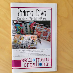 May include: A sewing pattern for a Prima Diva Clutch, Wallet, and Purse. The pattern includes instructions for making a wallet, clutch, or purse with a chain or wrist strap. The pattern is by Sew Many Creations.