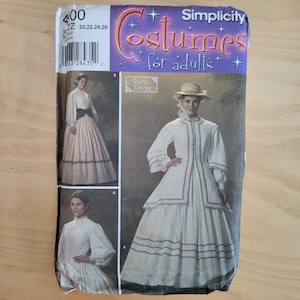 May include: A Simplicity sewing pattern envelope for costumes for adults, number 4100, featuring illustrations of long-sleeved white blouses and full-length skirts with dark trim. The package includes sizing information for 20, 22, 24, and 26.