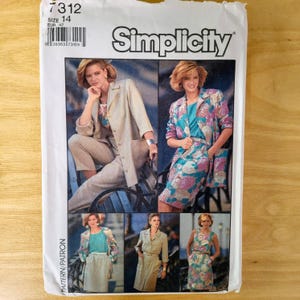May include: Simplicity sewing pattern envelope featuring a woman in a beige pantsuit and a woman in a floral print jacket and skirt. The envelope has the number 7312 and size 14.