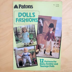 May include: A light green Patons Dolls Fashions pattern booklet, No. 17734, featuring 12 patterns for baby, toddler, and teenage dolls. The cover displays three photographs of dolls wearing knitted outfits, including a rider, a baby, and a toddler.