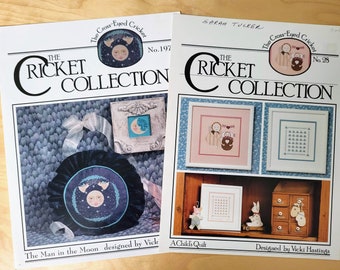 Set of 2 The Cricket Collection Cross Stitch Booklets A Child's Quilt and The Man in the Moon by Vicki Hastings