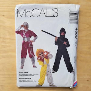 May include: McCall's costume pattern envelope featuring illustrations of a ninja, clown, and astronaut. The envelope includes the text "COSTUMES" and "DEGUISEMENTS" with size information. The costumes include a ninja, clown, and astronaut.