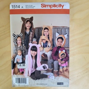 May include: A Simplicity sewing pattern for making hooded animal hats for children. The pattern shows a variety of hats, including a wolf, a fox, a bear, and a cat. The pattern is for sizes S-L.