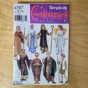 May include: A Simplicity sewing pattern envelope 4797 for kids' costumes. The front features illustrations of eight children wearing various historical and biblical outfits, including robes, crowns, and an angel costume with gold wings. Text includes 4797, Size A, S, M, L, and Costumes for kids.