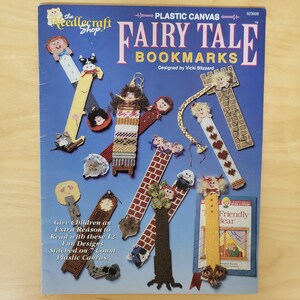 May include: A blue instructional booklet titled Plastic Canvas Fairy Tale Bookmarks by The Needlecraft Shop. The cover displays 12 colorful plastic canvas bookmark designs featuring characters, animals, and patterns, with text detailing 7-count canvas.