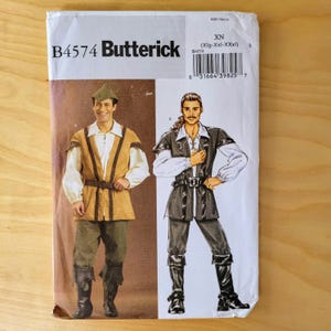 May include: A Butterick B4574 sewing pattern envelope for a costume featuring a tunic, shirt, and pants. The cover displays two illustrations of the outfit in tan and dark gray, including a pointed hat, long sleeves, and a belt with a buckle.