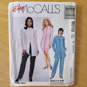 May include: McCall's sewing pattern featuring three women's fashion designs. The designs include a white long jacket with black pants, a pink tunic with a matching skirt, and a blue tunic with matching pants. The pattern size is C (10,12,14).